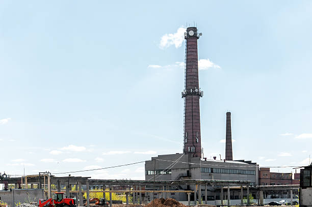 A large boiler house with a high chimney. Modern energy. Heat supply for factories and residential buildings. Energy production.