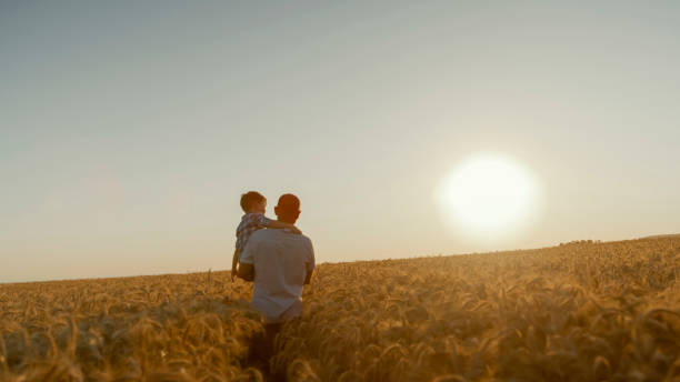 istock Caucasian Father and Son in Golden Wheat Field 2203778201