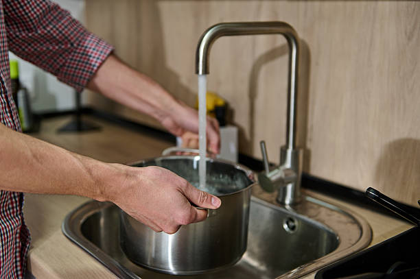 istock Man Washing a Cooking Pot 2203780229