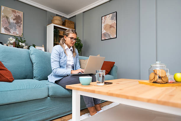 istock Young beautiful business woman lying on couch using laptop computer in home office apartment, working online, having video call. Creative female smiling, checking social media, typing message. 2203781004