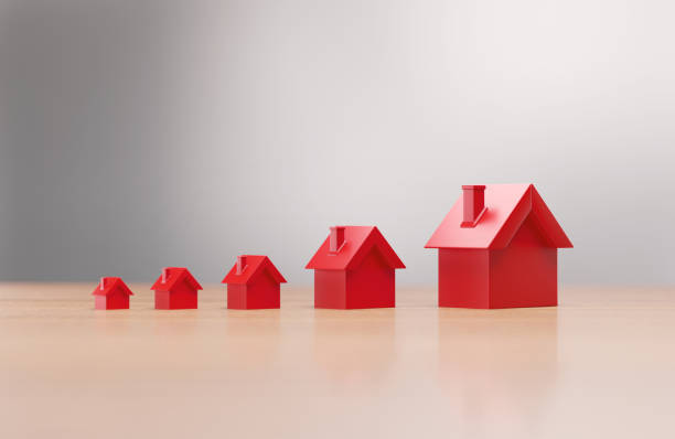 istock Red House Objects Forming A Chart Before Defocused Background - Real Estate Concept 2203781393