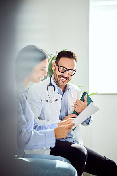 istock Doctor and Patient Discussing Medical Records in Bright Office Setting 2203782670
