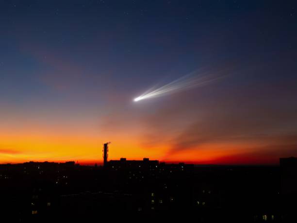 Comet over the city at sunset.