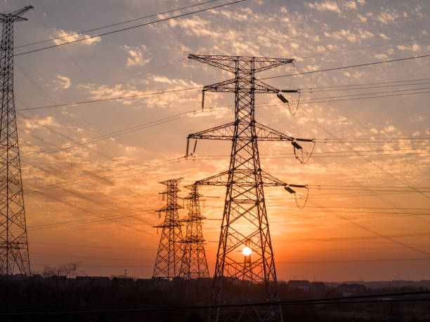istock Sunset silhouette of high voltage transmission lines 2203783541