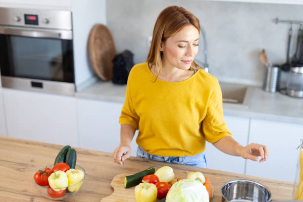 istock Focused Woman Organizing Ingredients in Kitchen 2203783896