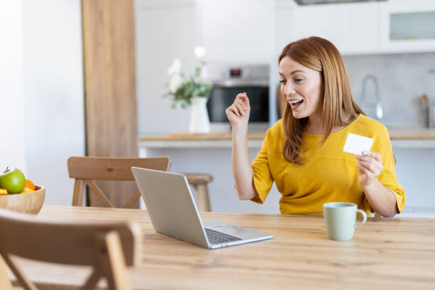 istock Happy woman celebrating a victory while using her laptop 2203783901