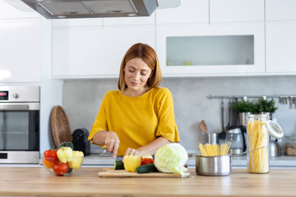 istock Smiling Cook Preparing Vegetables with Happiness in Kitchen 2203783907