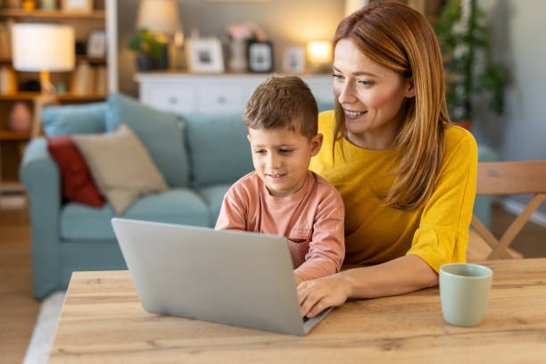 istock Caring Mother and Child Working on Laptop Together 2203783919