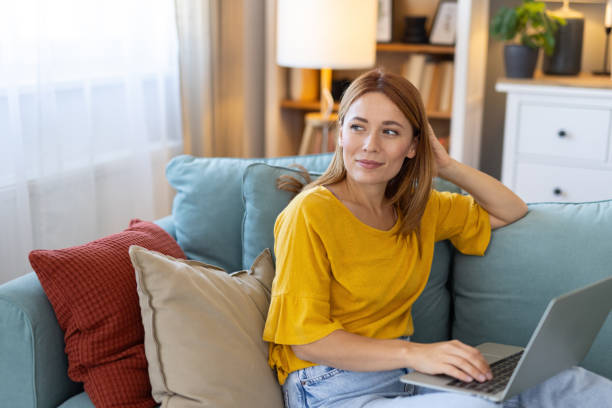 istock Woman using a laptop at home, expressive and focused vibe. 2203783931