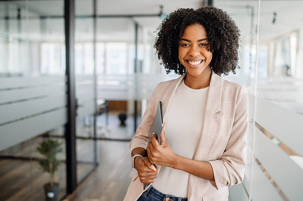 istock Confident young professional smiling in a modern office corridor 2203783968