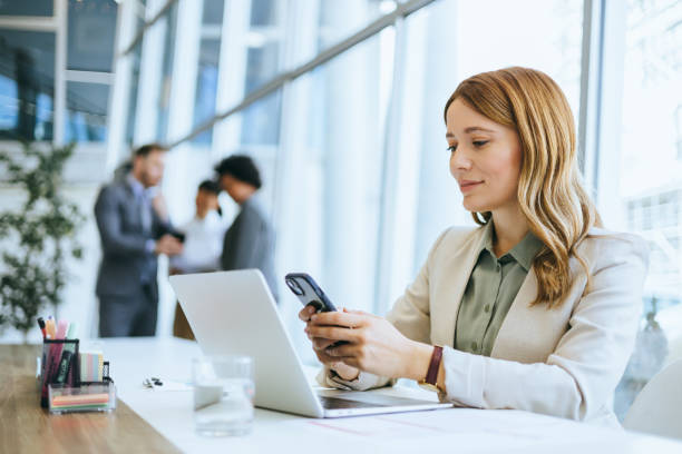 istock Businesswoman checking smartphone at work 2203786285
