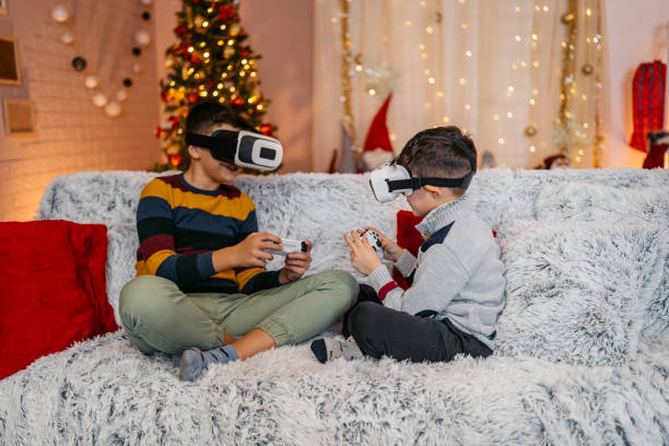 istock Two Boys Playing Video Games On A Joystick While Wearing Virtual Reality Headset At Home During Christmas Holidays 2203788204