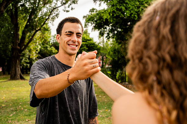istock Friends greeting each other in a public park 2203788860