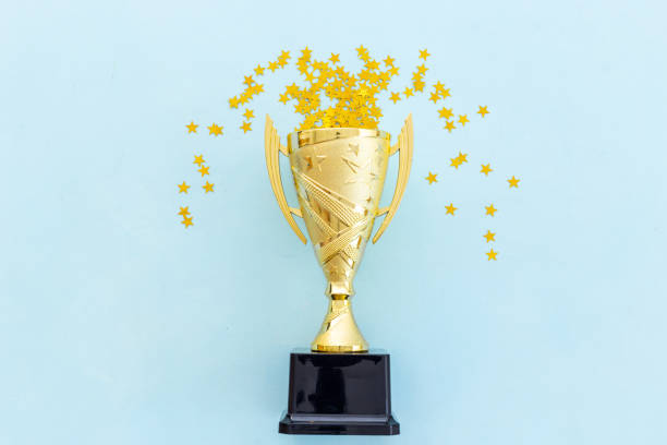 istock Award golden trophy cup, top view. First place winning the competition concept 2203789249