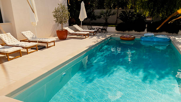 istock Sunlit Private Pool with Lounge Chairs and Relaxing Ambiance 2203789477