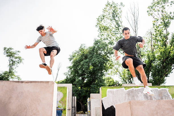 Friends practicing parkour in a public park