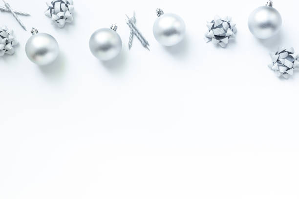 istock Frame of silver Christmas and New Year decorations on white background. Top view 2203789989