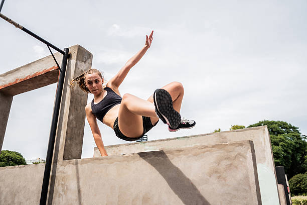 istock Free running athlete woman practicing parkour in a public park 2203790162