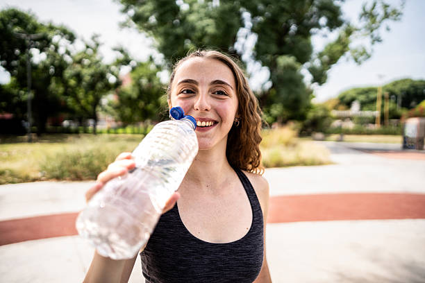istock Young athlete woman drinking water in a public park 2203790452