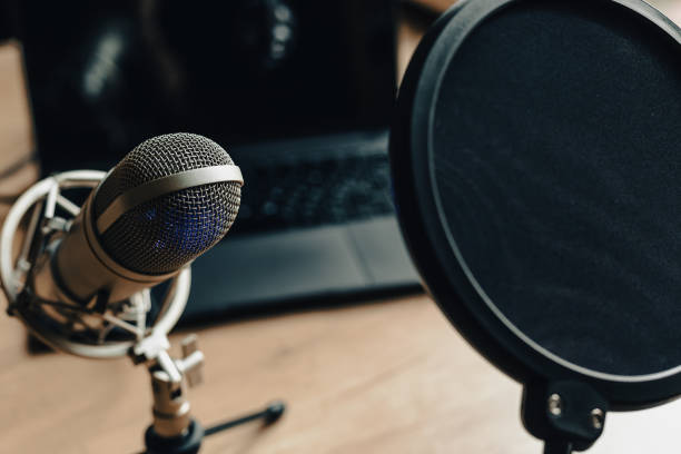 istock On the air concept - microphone with filter and laptop computer. Podcast recording 2203791854