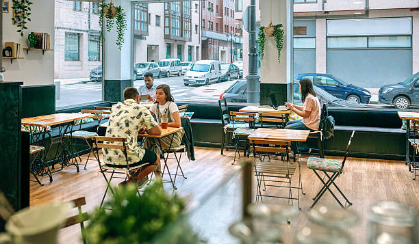 istock People enjoying their time working and relaxing at a modern cafe 2203791976