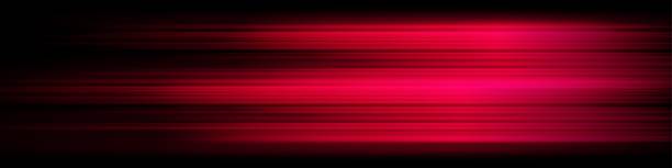 istock Horizontal motion blur with warm red hues on a dark background. The glowing streaks sense of speed, energy, and futuristic motion 2203793210