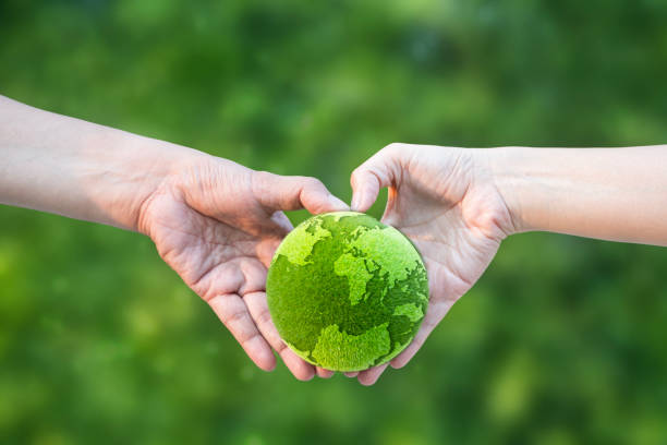 Hands cradle Mother Earth against a starfield background. Environmental awareness and an acceptance of responsibility for the care of our earthly home showing here.
