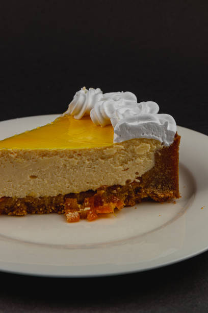 istock Delightful cheesecake slice topped with whipped cream and fruit 2203795132