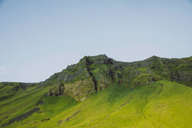 istock Green Cliffs and Rugged Peaks Under a Clear Blue Sky in Vik, South Iceland 2203799431