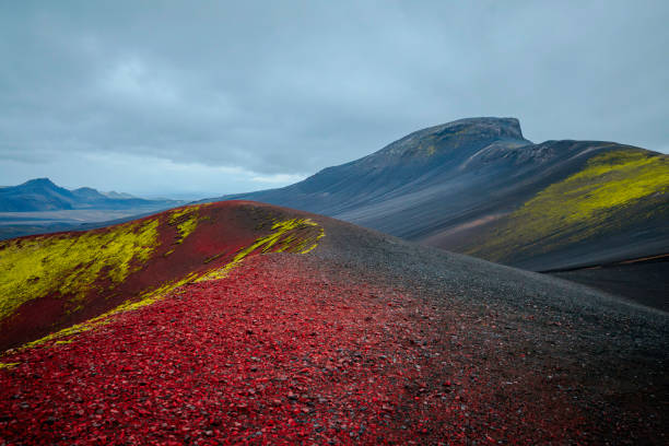 The Apple Crater, locally known as Raudaskal (“red bowl” in Icelandic), is a breathtaking volcanic formation in Iceland's highlands. This striking crater captivates with its deep red volcanic soil, contrasted by vibrant green moss that thrives on its slopes. The nickname \