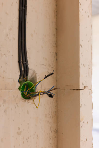 istock Electric sockets box in wall. Electric outlet installation. 2203800454
