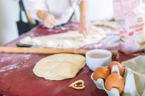 Woman rolling the cut dough into rolls