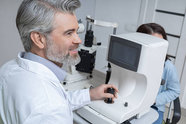 istock Doctor conducting vision test in optical workplace with professional devices 2203801362