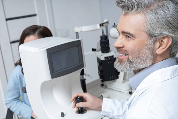 istock Professional optometrist in clinic sitting at workplace with advanced technology 2203801384