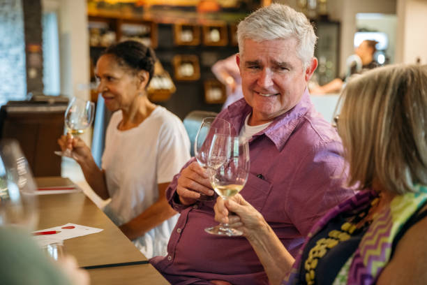 istock Seat mates at wine tasting touching glasses and smiling 2203802519