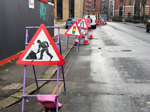Road works and temporary traffic light signs at a construction site on a street in Bristol