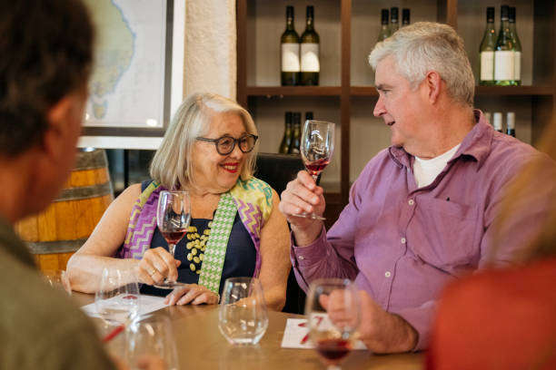 istock Social fun among senior guests at wine tasting event 2203803128