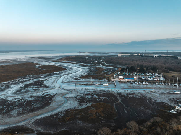 Low tide exposing mudflats in a marina at sunset