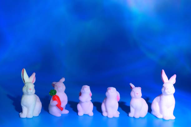 Toy rabbits on a blue background. Decorative animals.