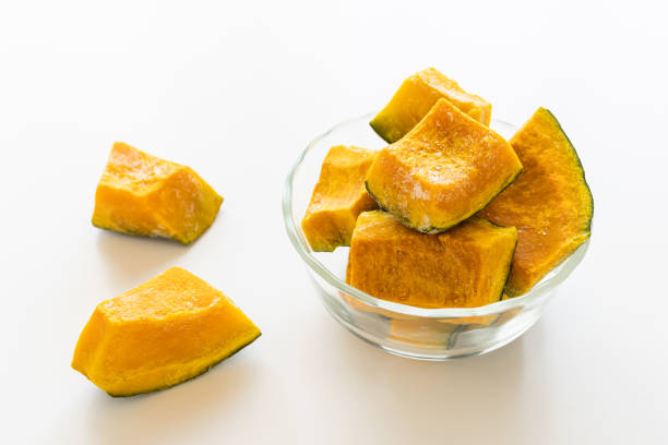 istock Frozen pumpkin. Cut frozen vegetable pumpkin, white background. 2203806297