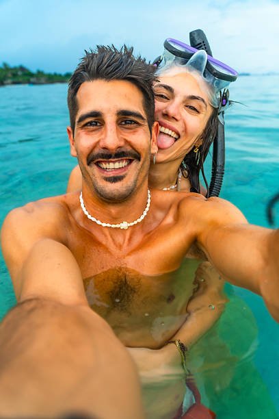 istock Couple taking a selfie while snorkeling in tropical water 2203808189