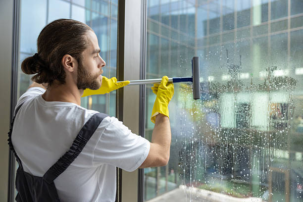 istock Cleaning person looking busy while cleaning the windows in the office 2203809253