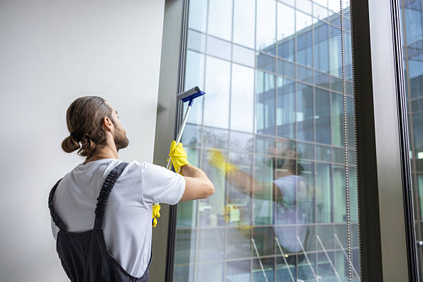 istock Young bearded service man looking busy while cleaning the office 2203809270