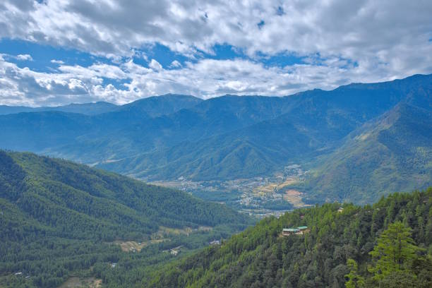 Paro Valley with rice fields, farmland, and surrounding forest near Tiger's Nest. The Taktsang Cafeteria in the foreground can be seen in the foreground