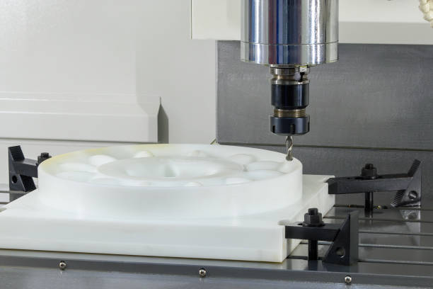 istock The CNC milling machine cutting the nylon parts with solid ball end mill tool. 2203811120