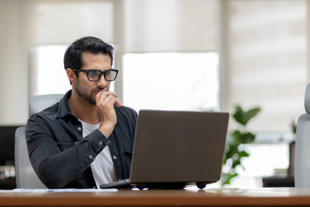 istock A dedicated investor working in a futuristic office, reviewing financial analytics on a digital tablet. Strategic business planning, innovation, and corporate success in a high-tech workspace. Confidence, leadership, and expertise in investment management 2203814268