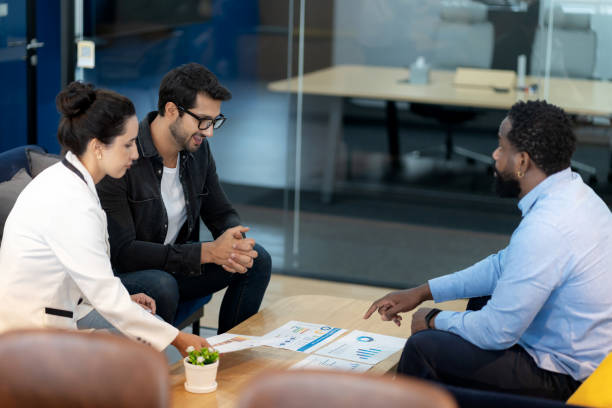 istock A multicultural group of professionals collaborates in a modern office, analyzing reports and exchanging ideas. With teamwork, innovation, and leadership, they discuss strategies for business growth, emphasizing cooperation, creativity, and success. 2203814277