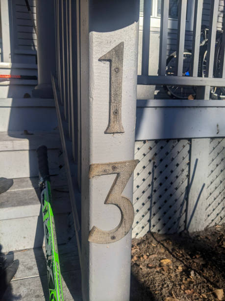 istock House Number 13 Displayed on a Wooden Porch Post in Sunlight 2203814657