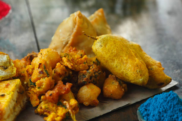 istock mix pakora ( bread pakora, onion pakora, moong dal pakora, mirchi vada, samosa, aloo pakora) with holi color 2203817885