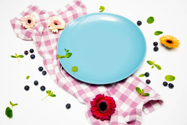 istock Spring Food with Blue Ceramic Plate on Checkered Cloth with Flowers and Green Leaves – Rustic Table Setting 2203818201